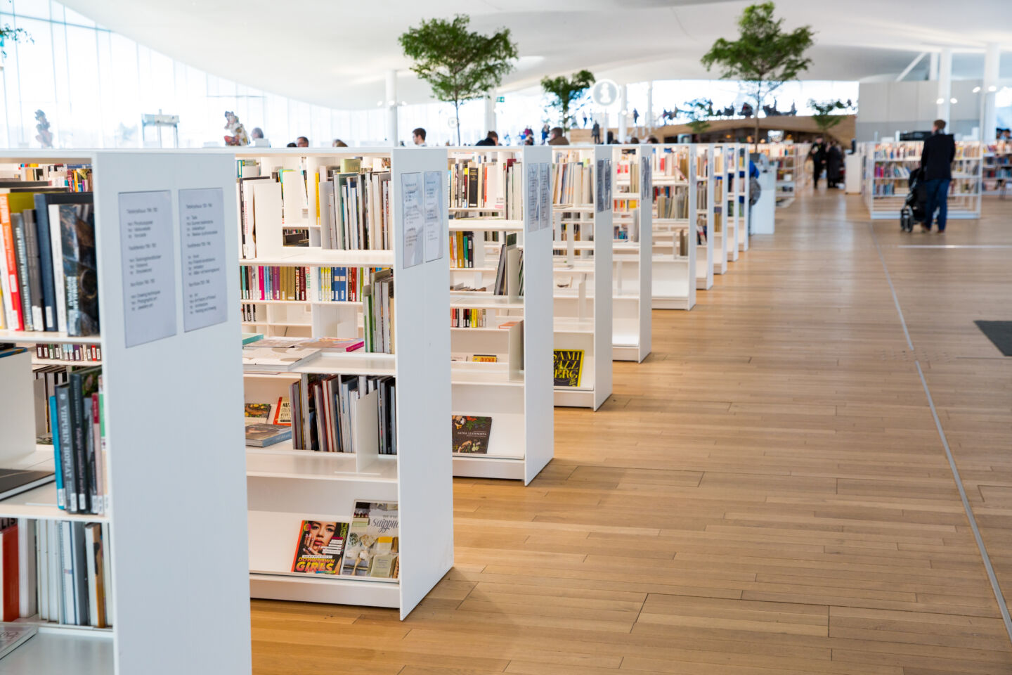 Helsinki, Finland- March 22 2019: New Helsinki central library Oodi interior. Light and spacious modern northern architecture. Bookshelves, working space. People reading, working, relaxing, studying.