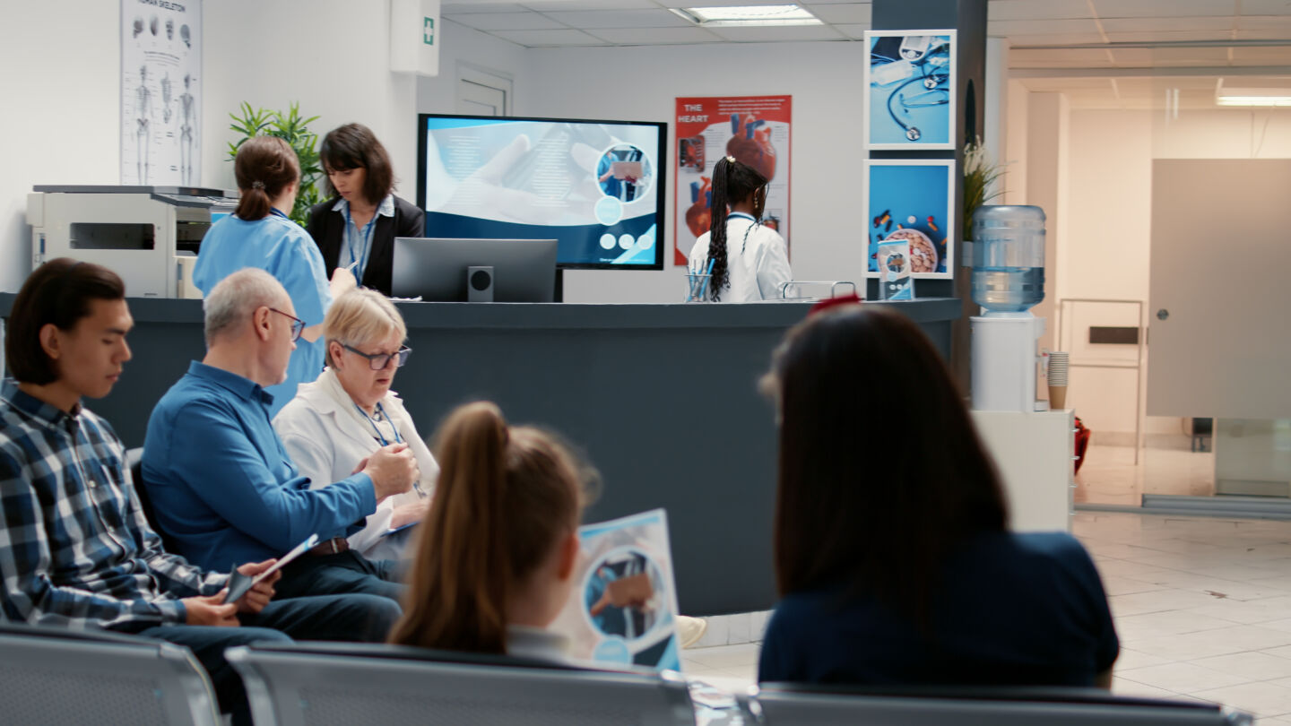 Busy hospital reception with diverse group of patients